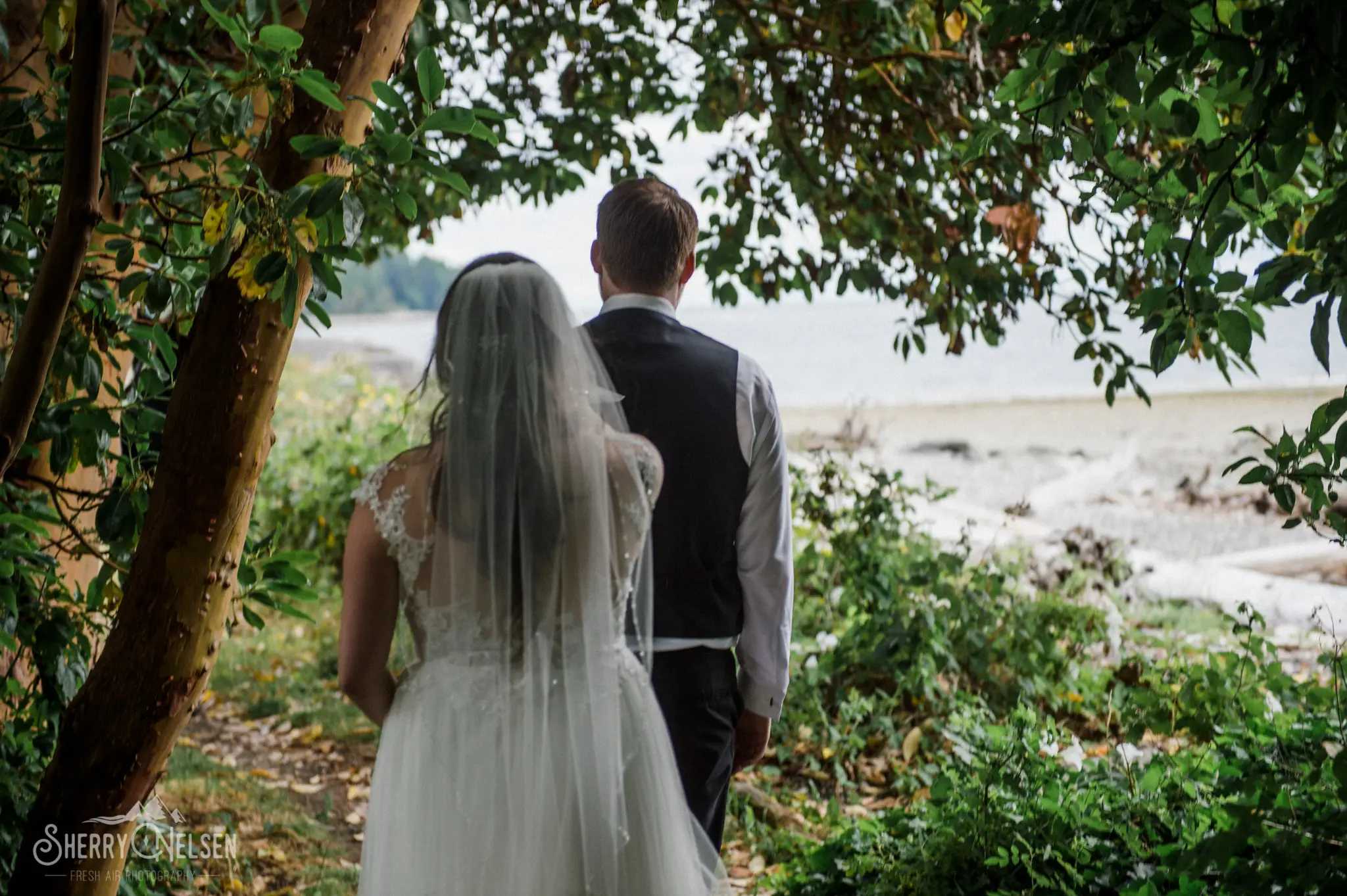 bride taps the groom on the shoulder to turn around and he will get to see her dressed as his bride