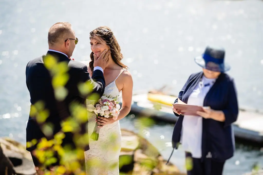 groom touches bride's face during sunshine coast wedding ceremony