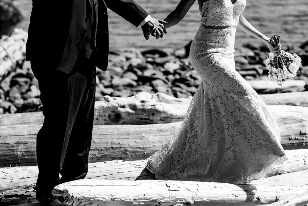 bride and groom explore beach on the sunshine coast