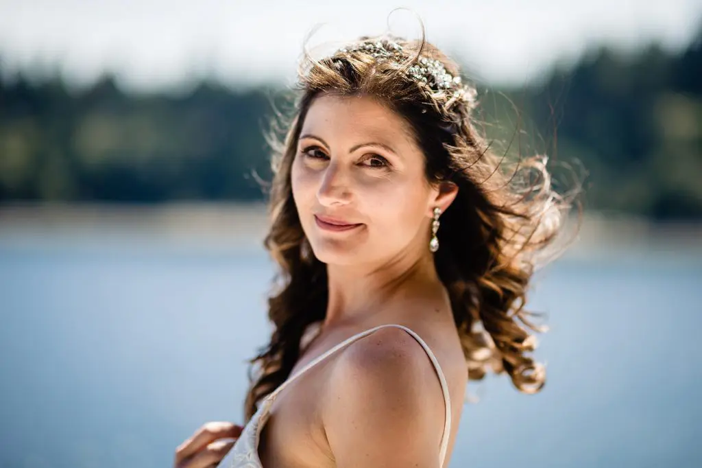 bride posing on balcony overlooking ocean