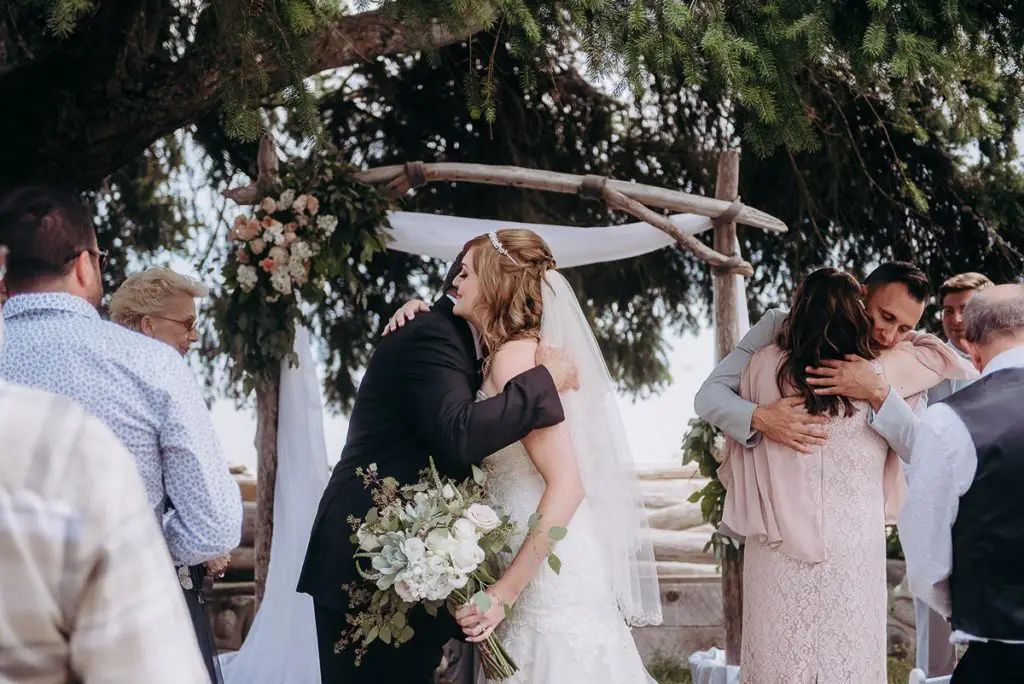 a hug from her father at the alter as he gives her away Sunshine Coast BC wedding