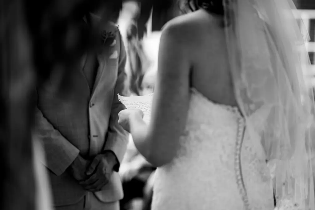 bride reads her letter to her husband as they marry at this Sunshine Coast wedding