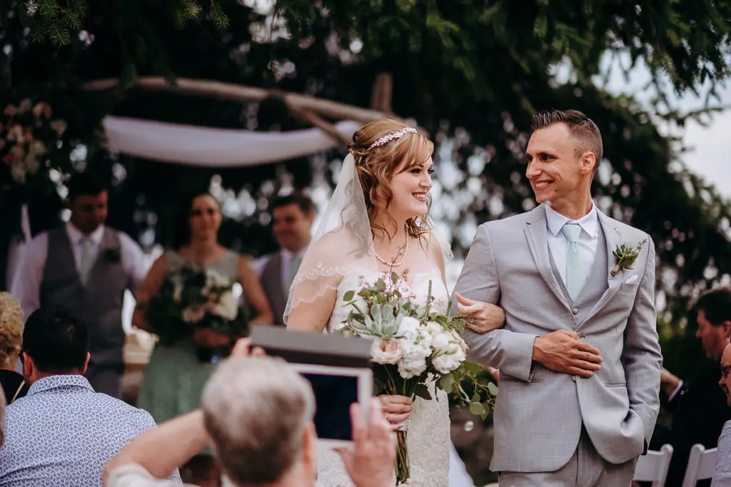 bride and groom look at each other in excitement as they are pronounced man and wife at their Sunshine Coast wedding