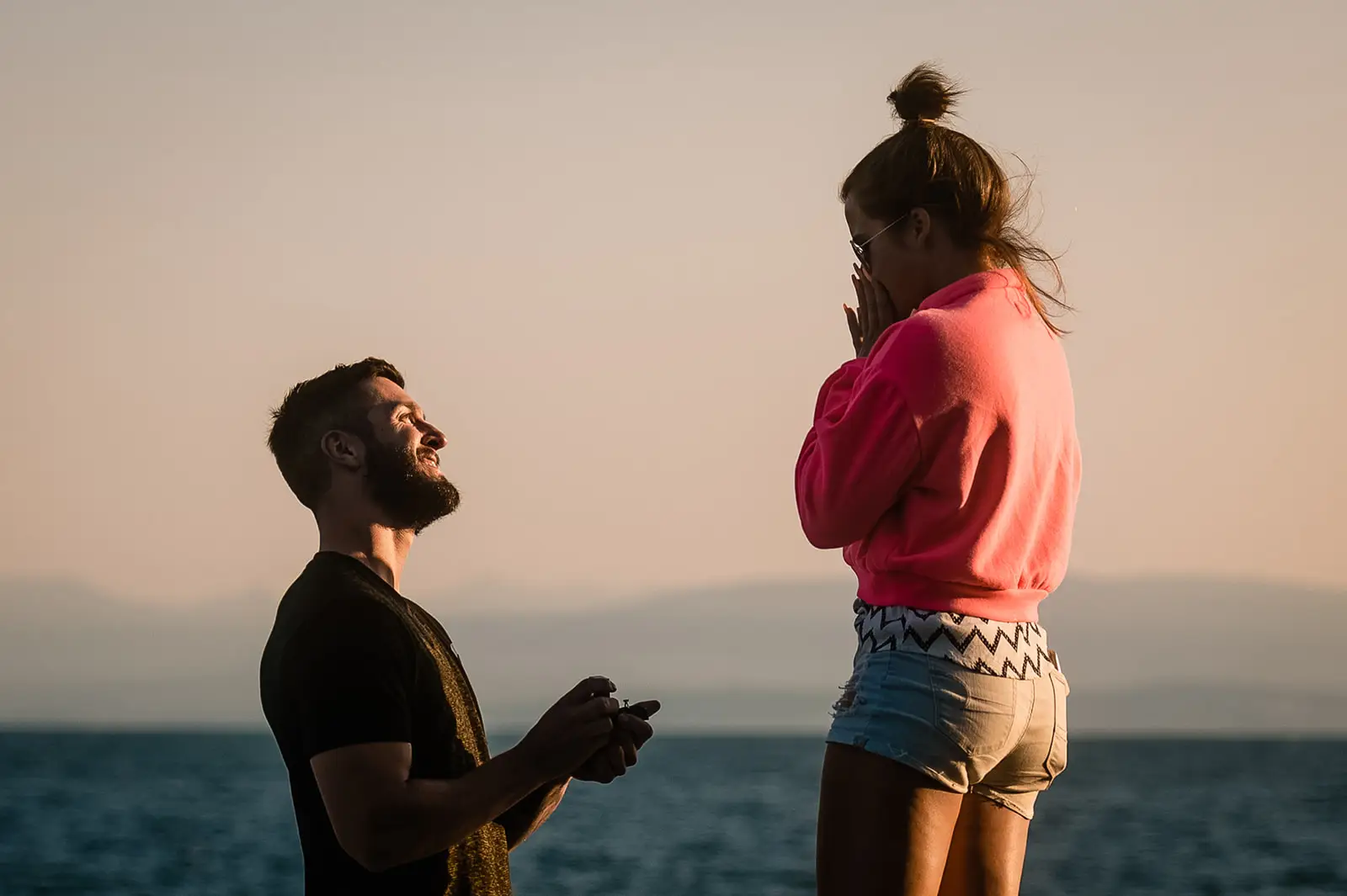 man proposes to his girlfriend on the beach in Sechelt at sunset.