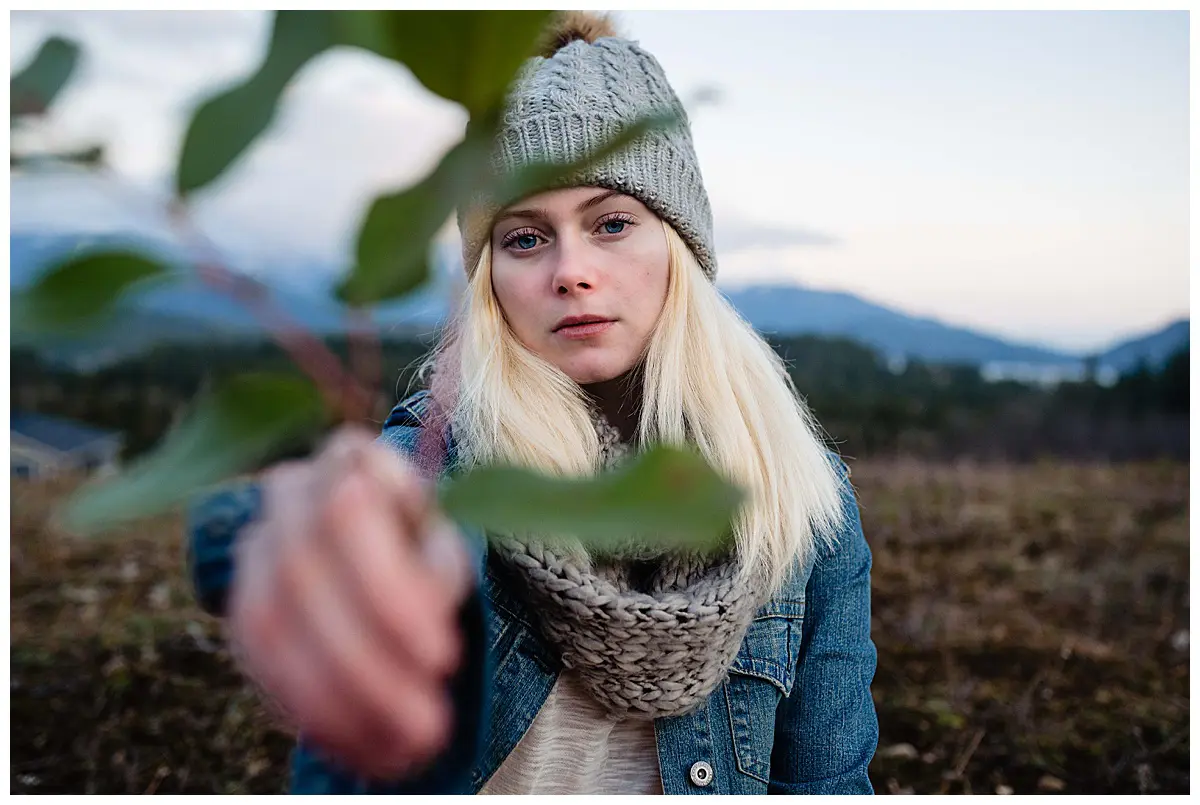 Girl walking in the mountains with salal at a mountain adventure story 