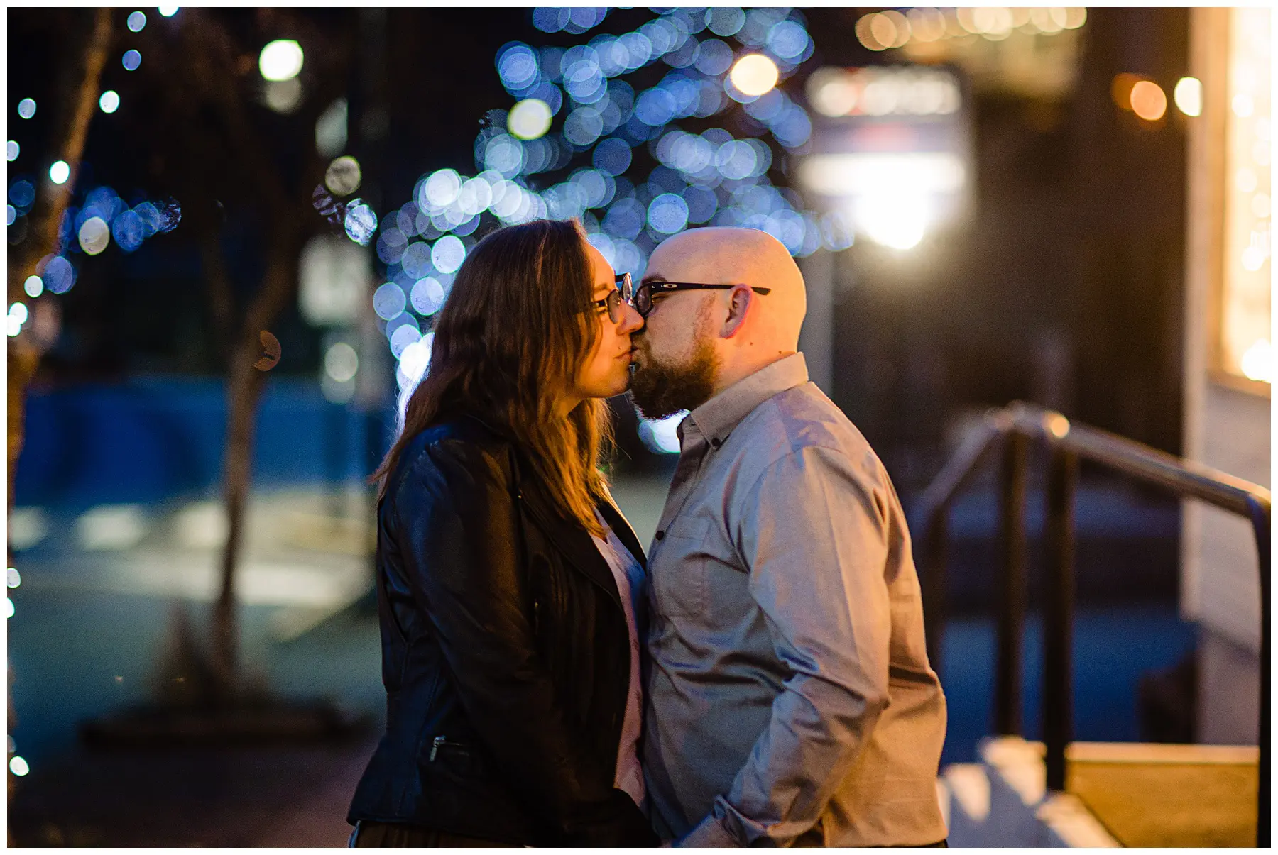 Newly engaged couple kiss under the lights in Gibsons