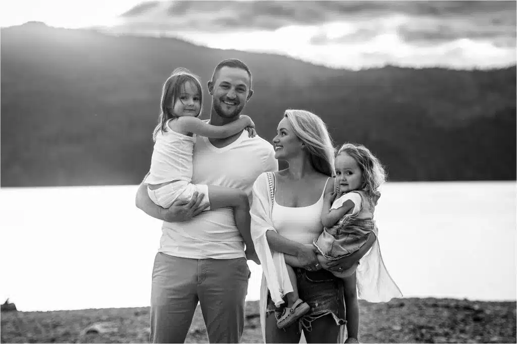 a young family with a mom, dad, and two little girls enjoy a family photo day with fresh air photography sherry nelsen